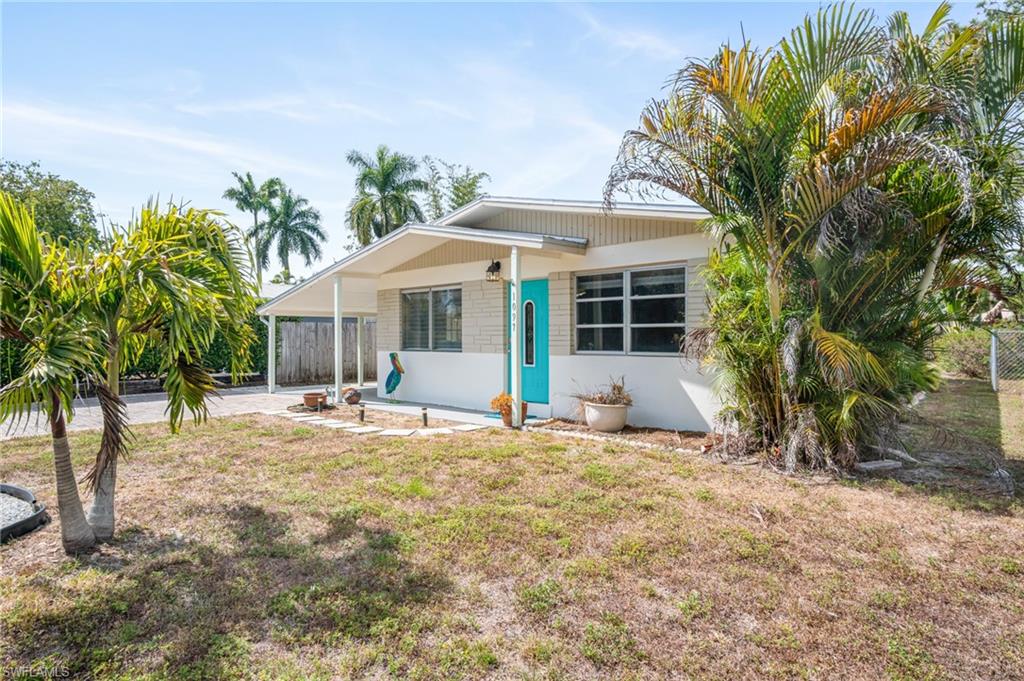 1097 Sperling Avenue Naples, FL 34103 - Photo 35 of 37 a view of a house with backyard and sitting area