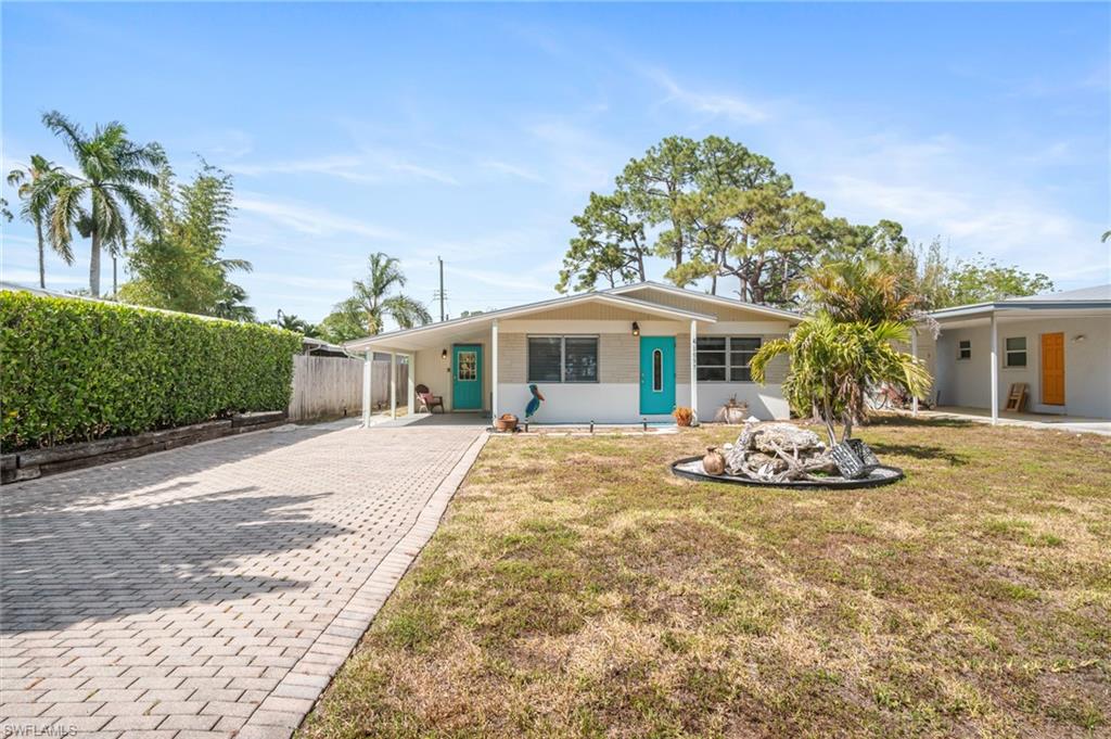 1097 Sperling Avenue Naples, FL 34103 - Photo 36 of 37 a front view of a house with garden