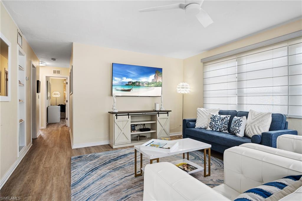 1097 Sperling Avenue Naples, FL 34103 - Photo 6 of 37 a living room with furniture a wooden floor and a stove