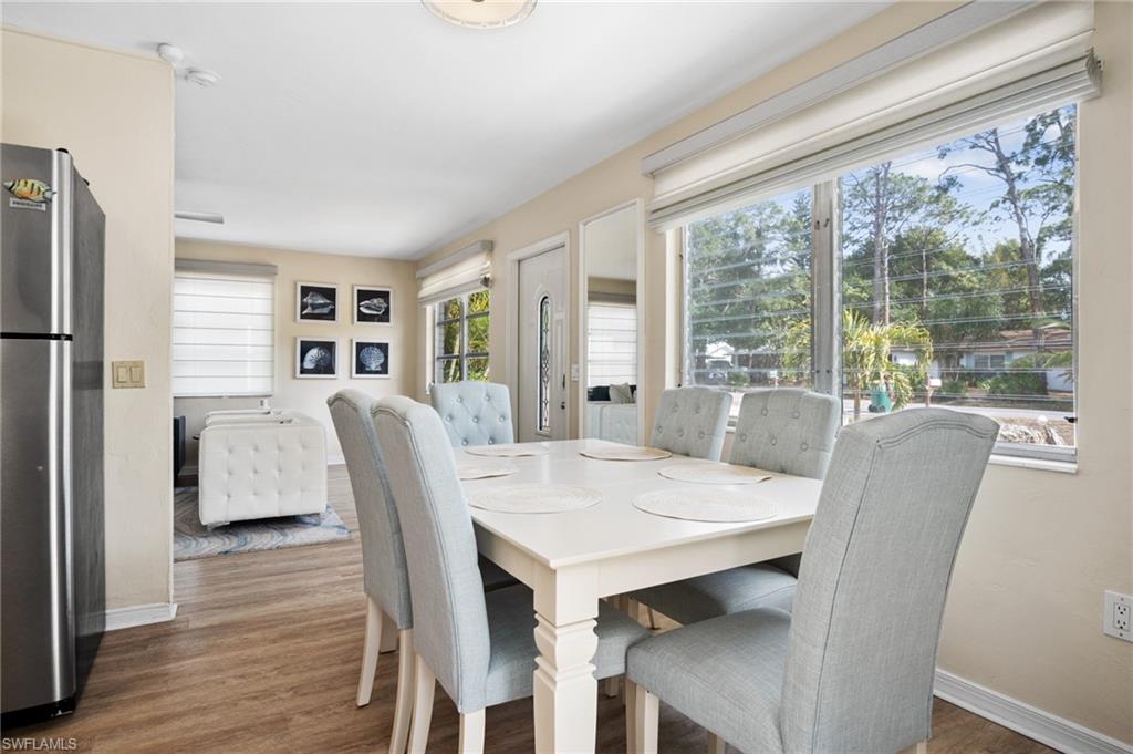 1097 Sperling Avenue Naples, FL 34103 - Photo 7 of 37 a view of a dining room with furniture window and wooden floor