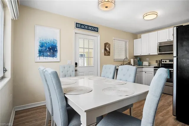 a view of a dining room with furniture and a window