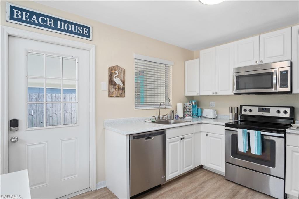 1097 Sperling Avenue Naples, FL 34103 - Photo 10 of 37 a kitchen with a sink stove and microwave