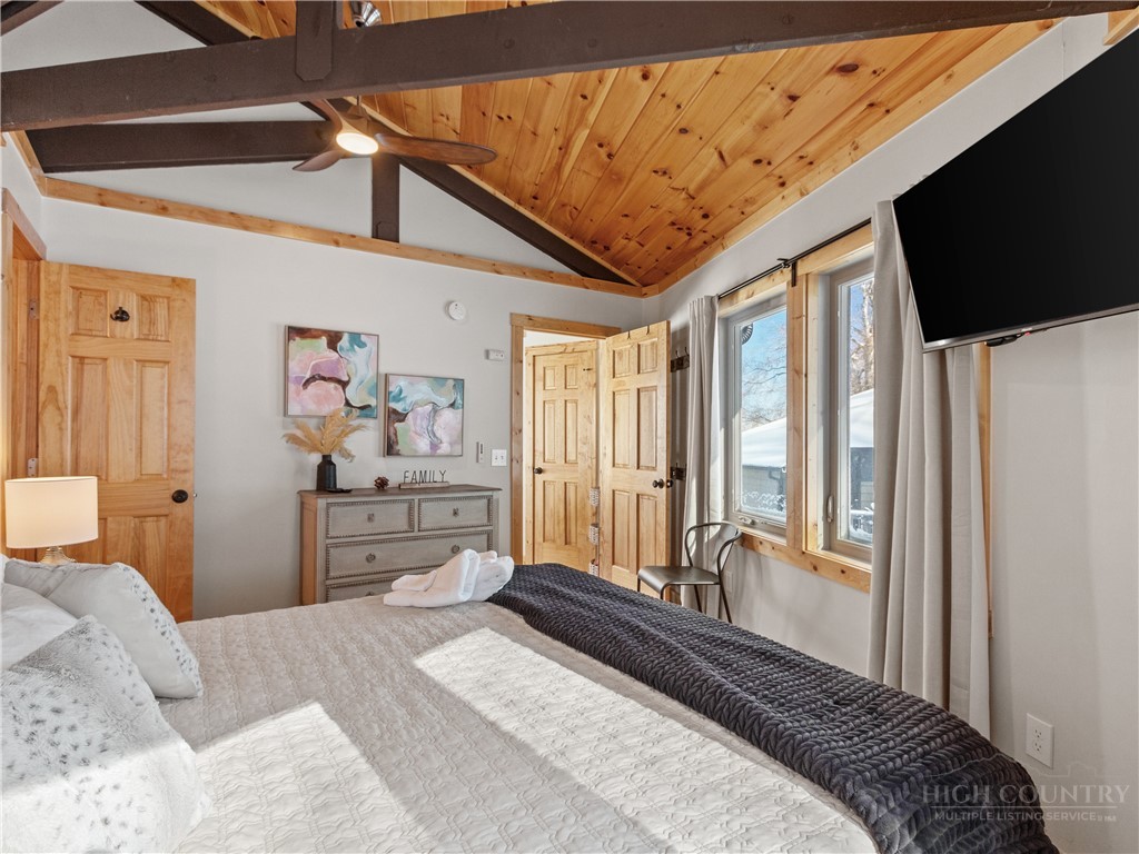 630 Briarcliff Road Sugar Mountain, NC 28604 - Photo 20 of 28 a bedroom with a bed a dresser and flat screen tv