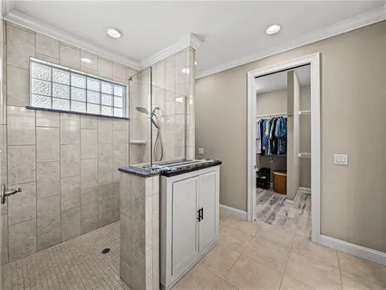 a dining room with furniture and a floor to ceiling window