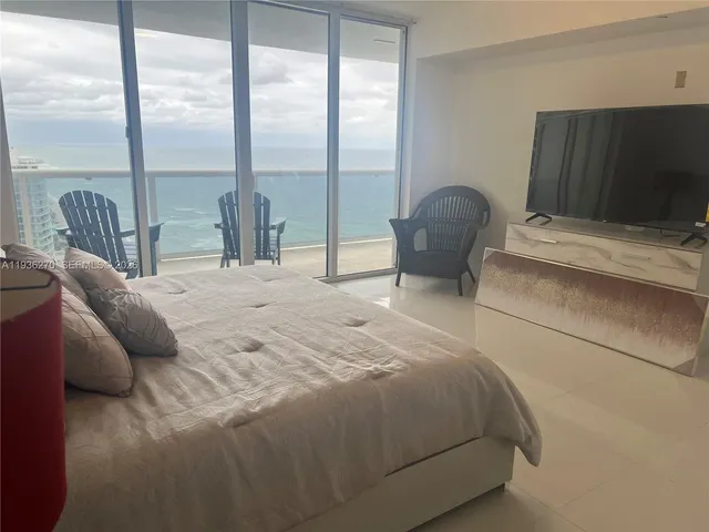 a bedroom with a bed chair and window