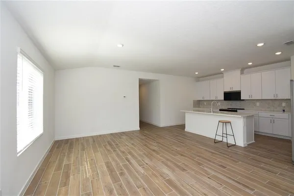 a view of an empty room and wooden floor