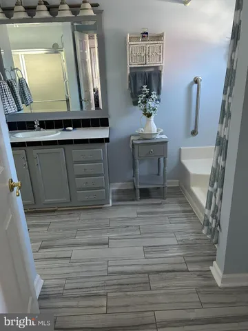 a living room with furniture and a mirror