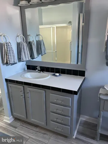 a bathroom with a sink a mirror and vanity