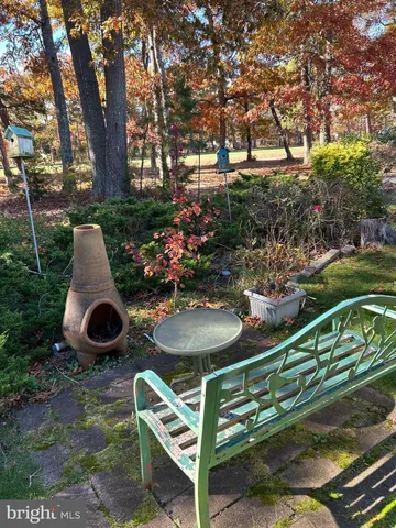 a table and chairs sitting in the garden