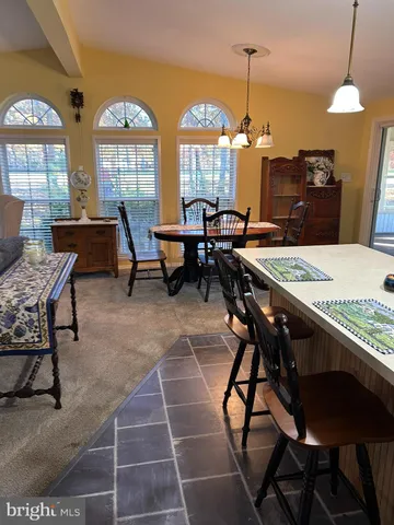 a view of a dining room with furniture and a chandelier