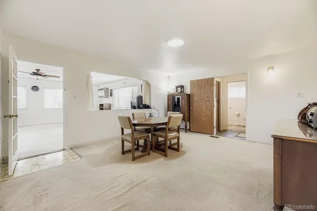 a view of a livingroom with furniture and a refrigerator