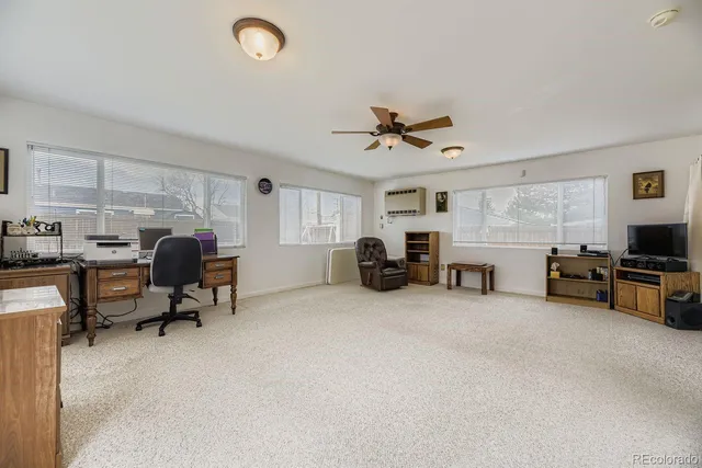 a view of a livingroom with workspace and a window