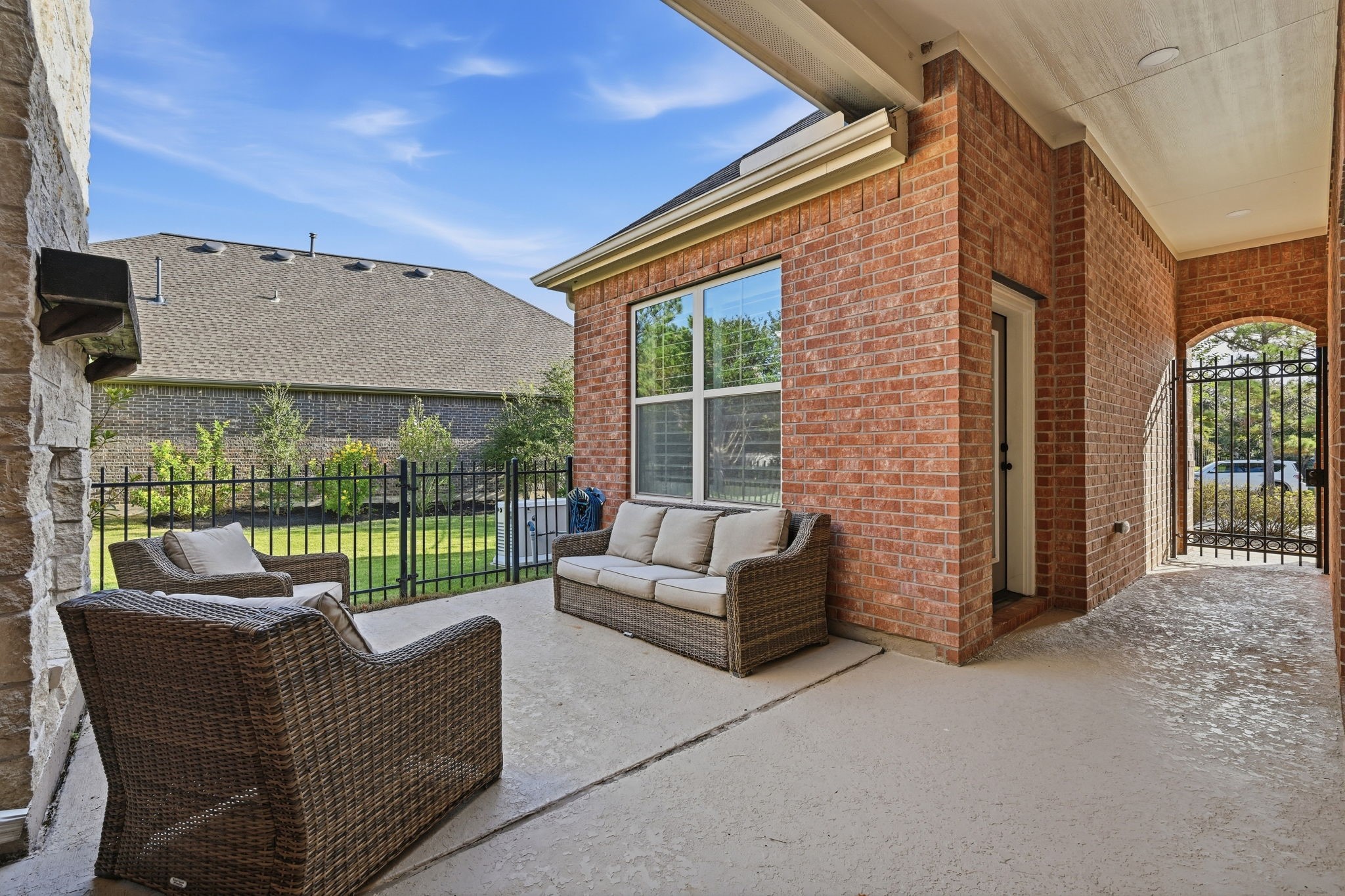 7 Sleeping Colt Place Spring, TX 77389 - Photo 24 of 32 Private covered courtyard creates a comfortable outdoor living space just inside the gated entry.