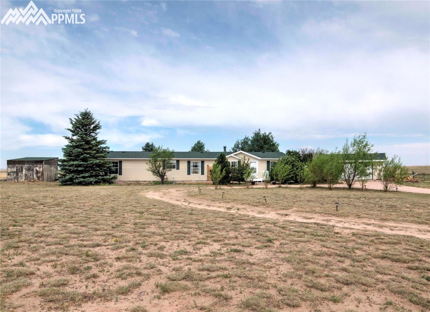 890 Ranchette Place Calhan, CO 80808 - Photo 1 of 26 Great house on 5 acres with a loafing shed, 2 car detached garage and nice trees.
