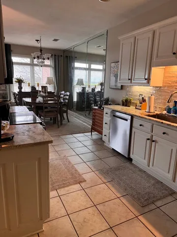 a kitchen with counter top space cabinets appliances and a window