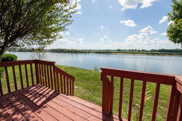 a view of a wooden deck with lake view