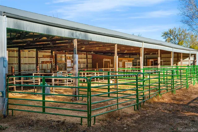 a view of entrance gate of the house and front view of a house