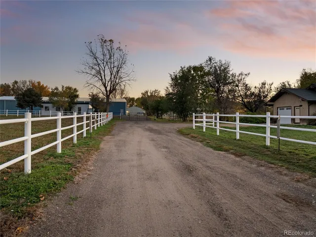 a view of a yard with wooden fence