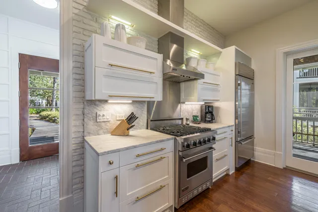 a kitchen with a stove and a wooden floors