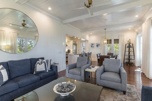 a living room with furniture and a mirror