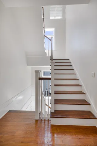 a view of entryway and hall with wooden floor