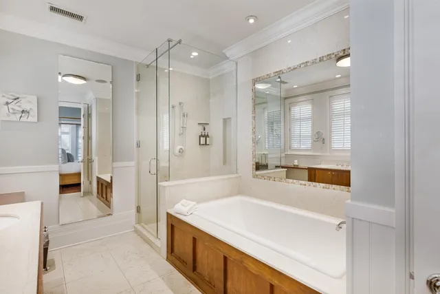 a spacious bathroom with a tub shower and sink