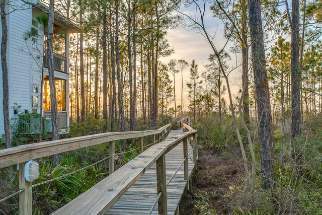 a view of a wooden balcony and trees