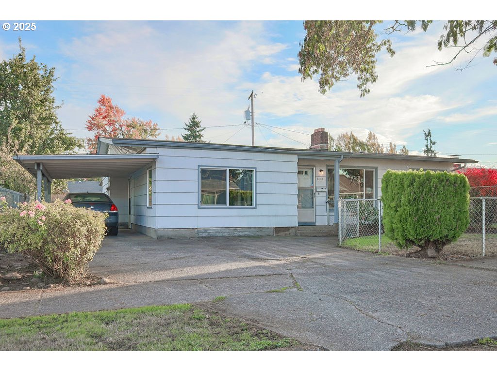 1355 Quinalt Street Springfield, OR 97477 - Photo 4 of 32 a view of a house with a yard and potted plants