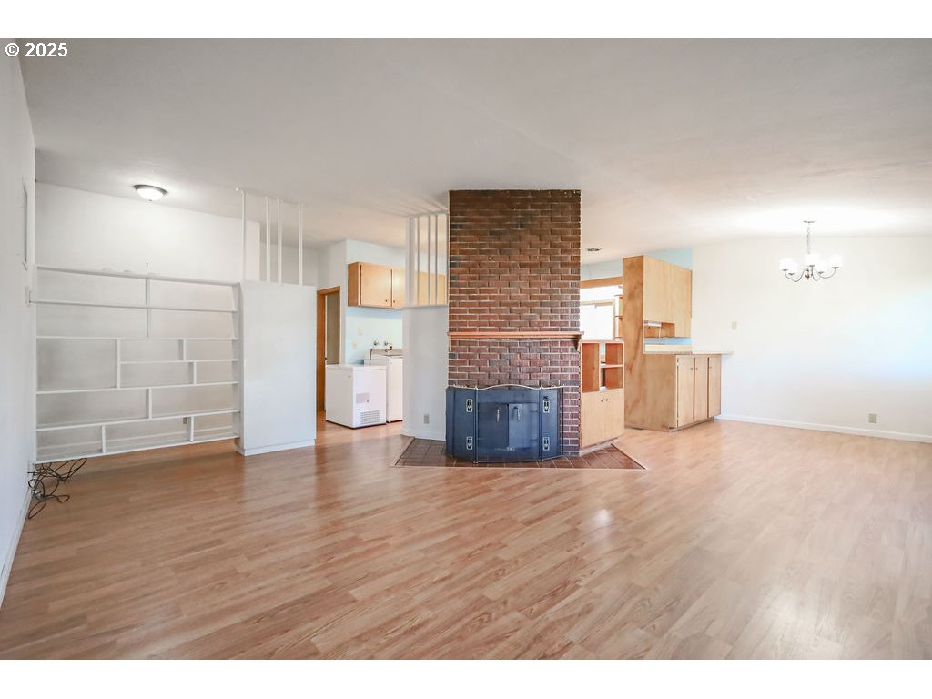 1355 Quinalt Street Springfield, OR 97477 - Photo 8 of 32 a view of empty room with wooden floor and fireplace