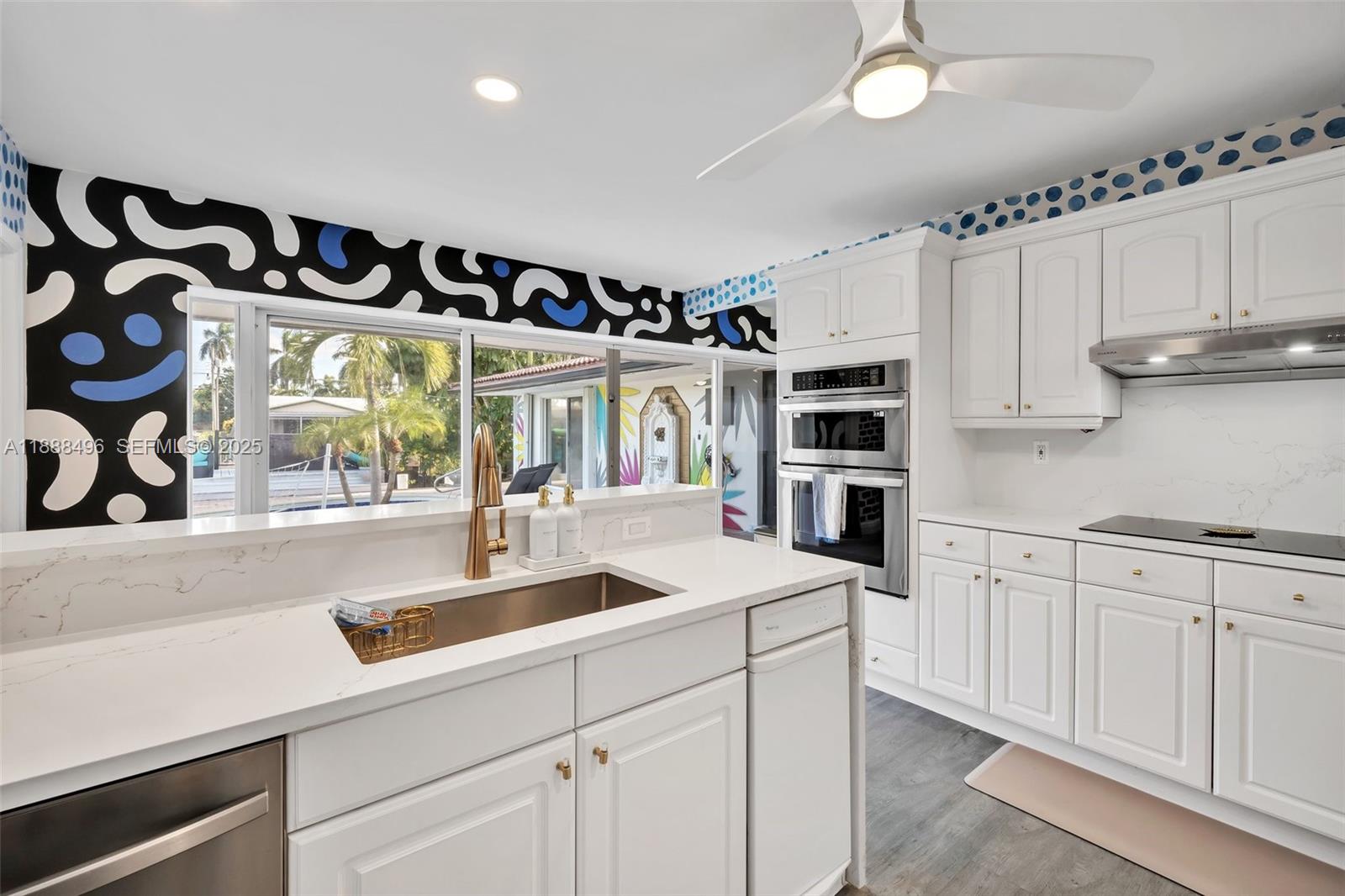 5830 Northeast 14th Road Fort Lauderdale, FL 33334 - Photo 20 of 46 a kitchen with stainless steel appliances granite countertop a sink and a stove