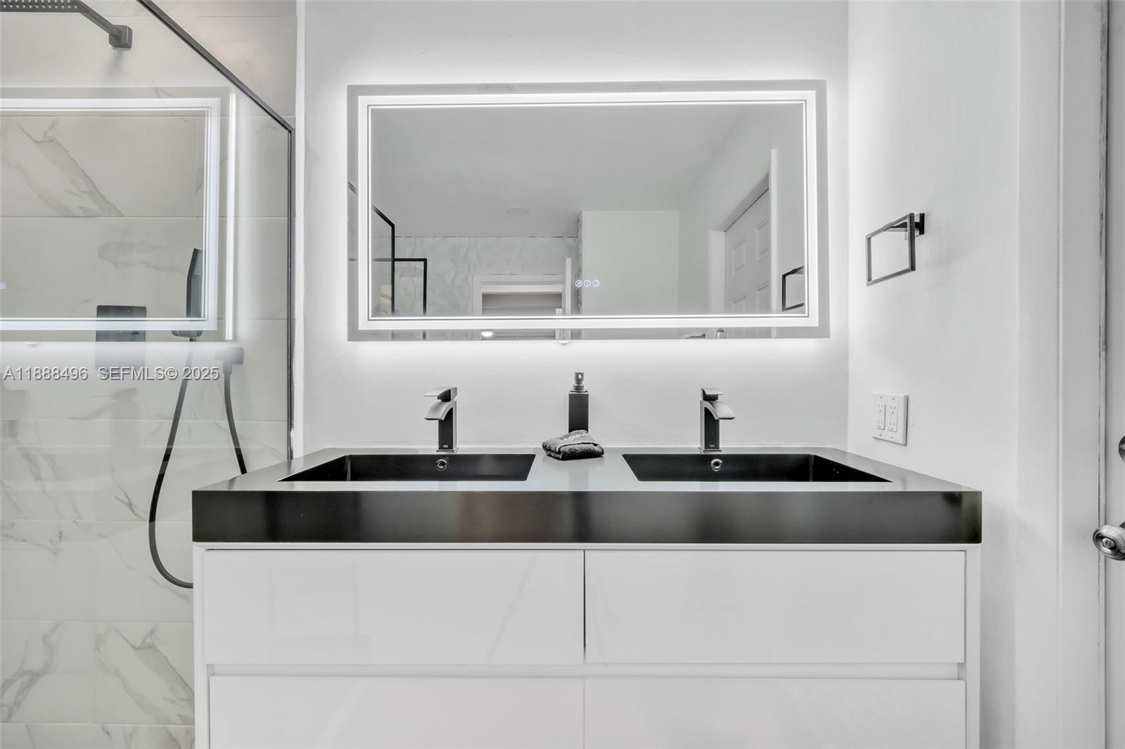 5830 Northeast 14th Road Fort Lauderdale, FL 33334 - Photo 24 of 46 a kitchen with a sink and a mirror