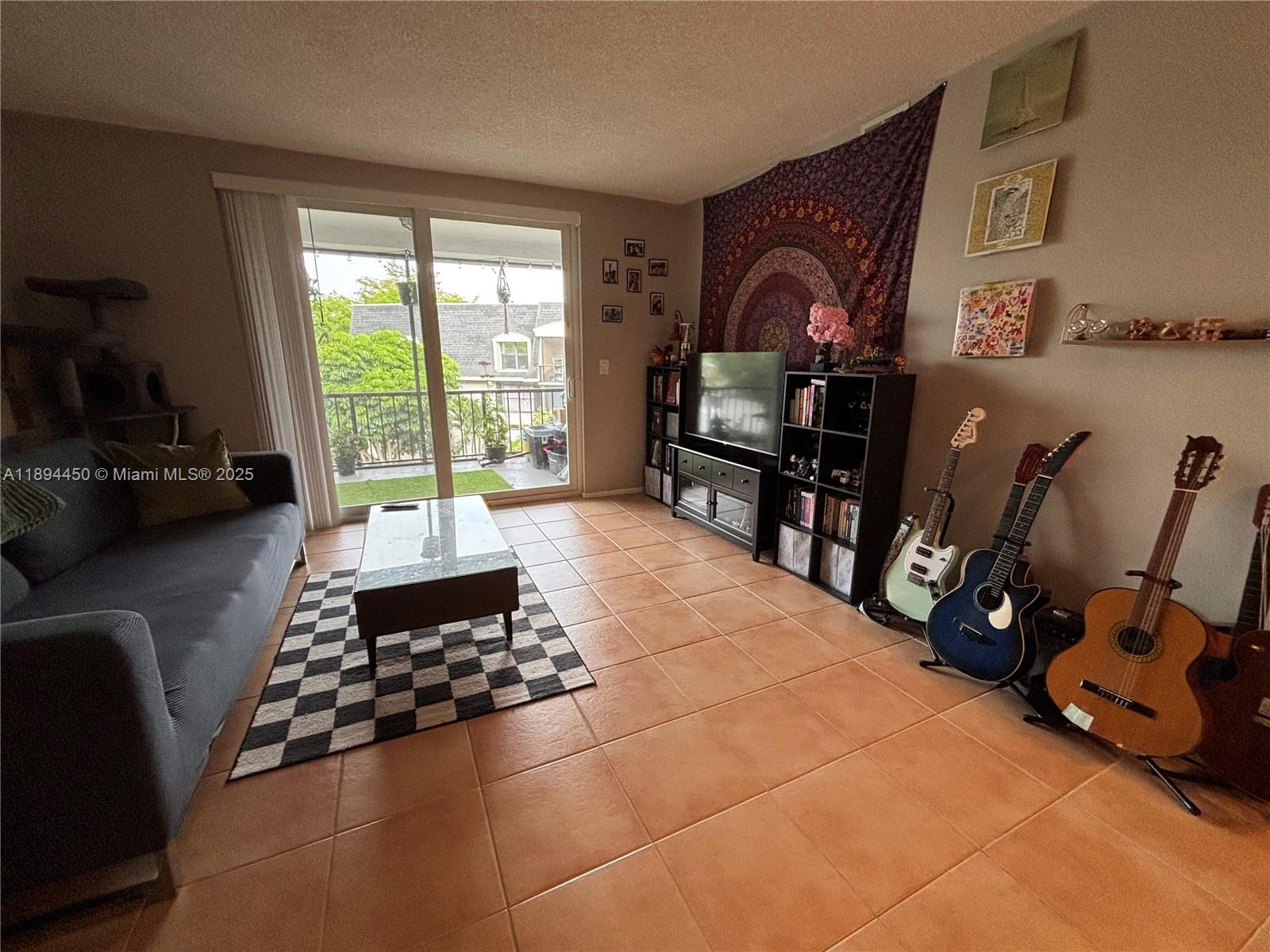 3650 Inverrary Drive, Unit 3YG Lauderhill, FL 33319 - Photo 11 of 38 a room with furniture a rug and a window