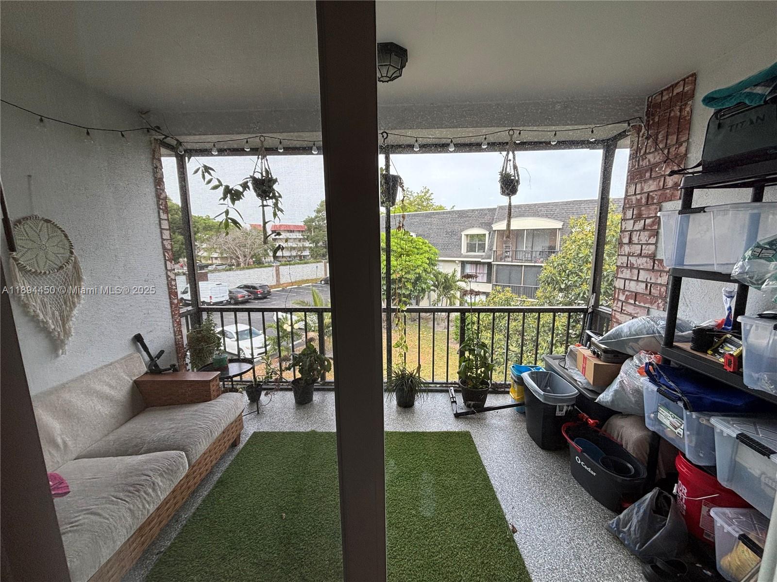 3650 Inverrary Drive, Unit 3YG Lauderhill, FL 33319 - Photo 14 of 38 a living room with furniture floor to ceiling window and a flat screen tv