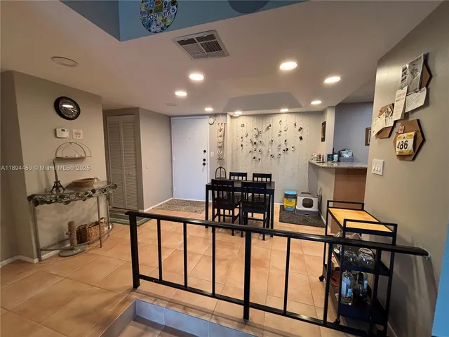a view of a dining room with furniture and a chandelier