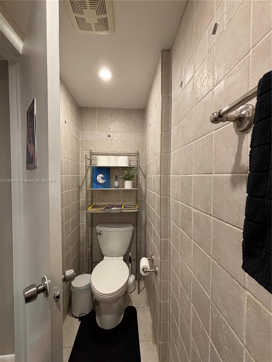 3650 Inverrary Drive, Unit 3YG Lauderhill, FL 33319 - Photo 28 of 38 a bathroom with a toilet and a shower