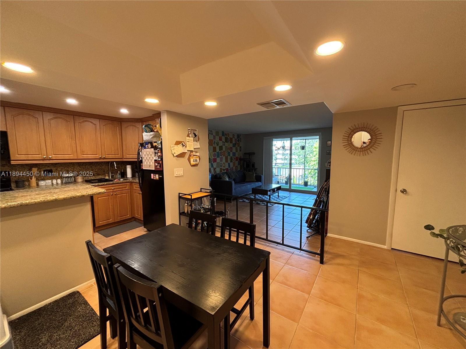 3650 Inverrary Drive, Unit 3YG Lauderhill, FL 33319 - Photo 30 of 38 a kitchen with a table and chairs in it