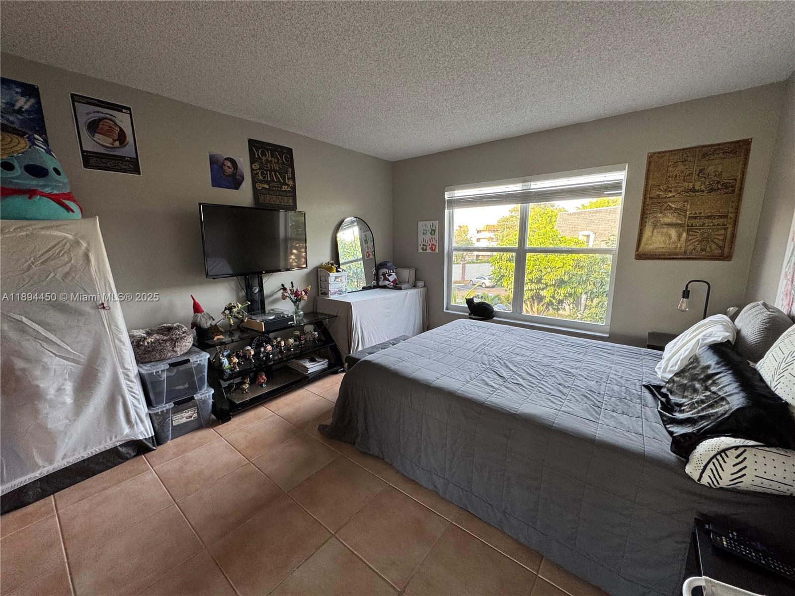 3650 Inverrary Drive, Unit 3YG Lauderhill, FL 33319 - Photo 34 of 38 a bed room with a bed and a large window