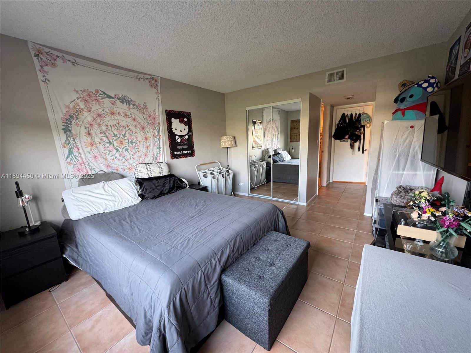 3650 Inverrary Drive, Unit 3YG Lauderhill, FL 33319 - Photo 35 of 38 a bedroom with a bed a couch and dresser