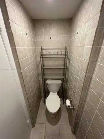 a bathroom with a toilet and a floor to ceiling window