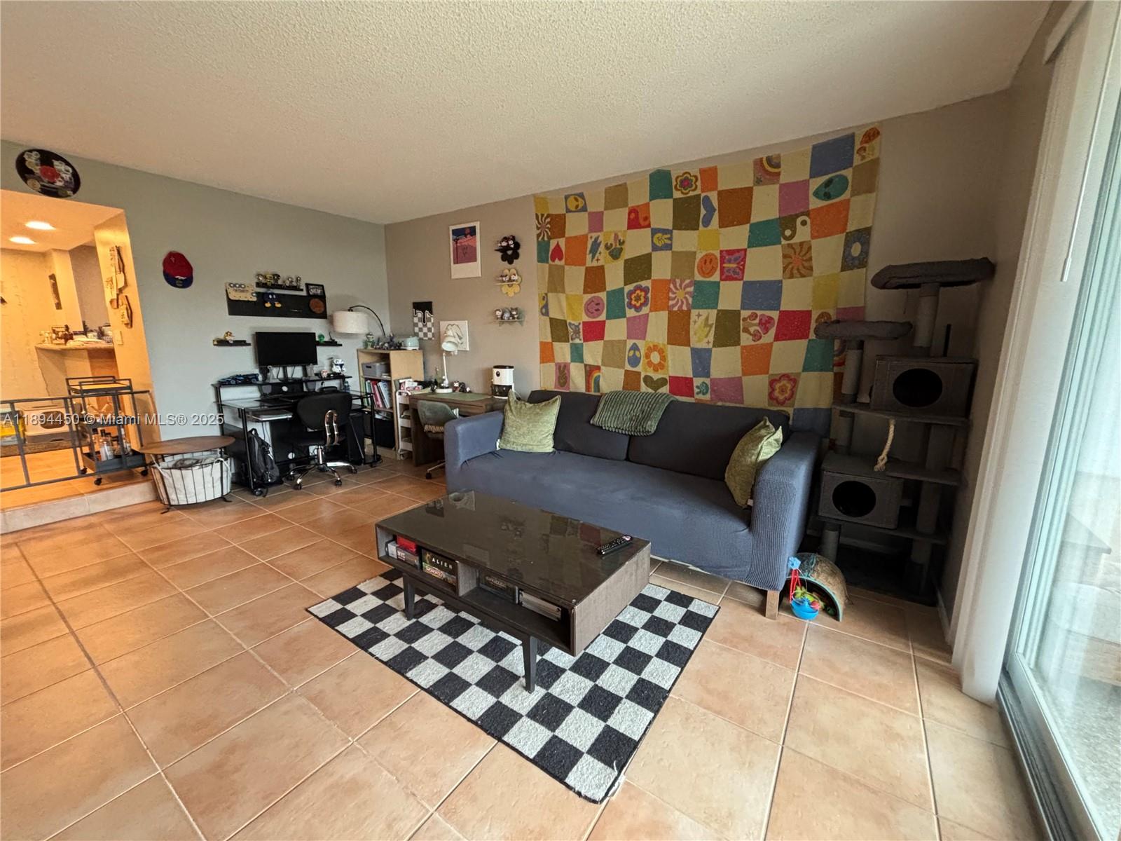 3650 Inverrary Drive, Unit 3YG Lauderhill, FL 33319 - Photo 10 of 38 a living room with furniture and a flat screen tv