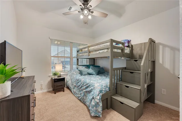 a bedroom with a large bed and a chandelier