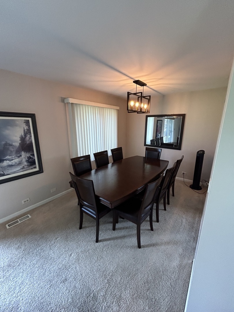 209 East Irving Park Road, Unit 1N Itasca, IL 60143 - Photo 13 of 30 a dining room with furniture and window