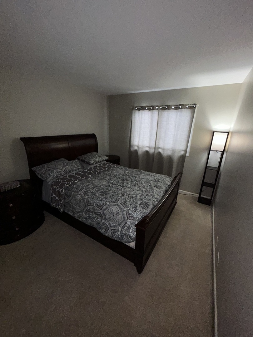 209 East Irving Park Road, Unit 1N Itasca, IL 60143 - Photo 21 of 30 a bedroom with a bed and window