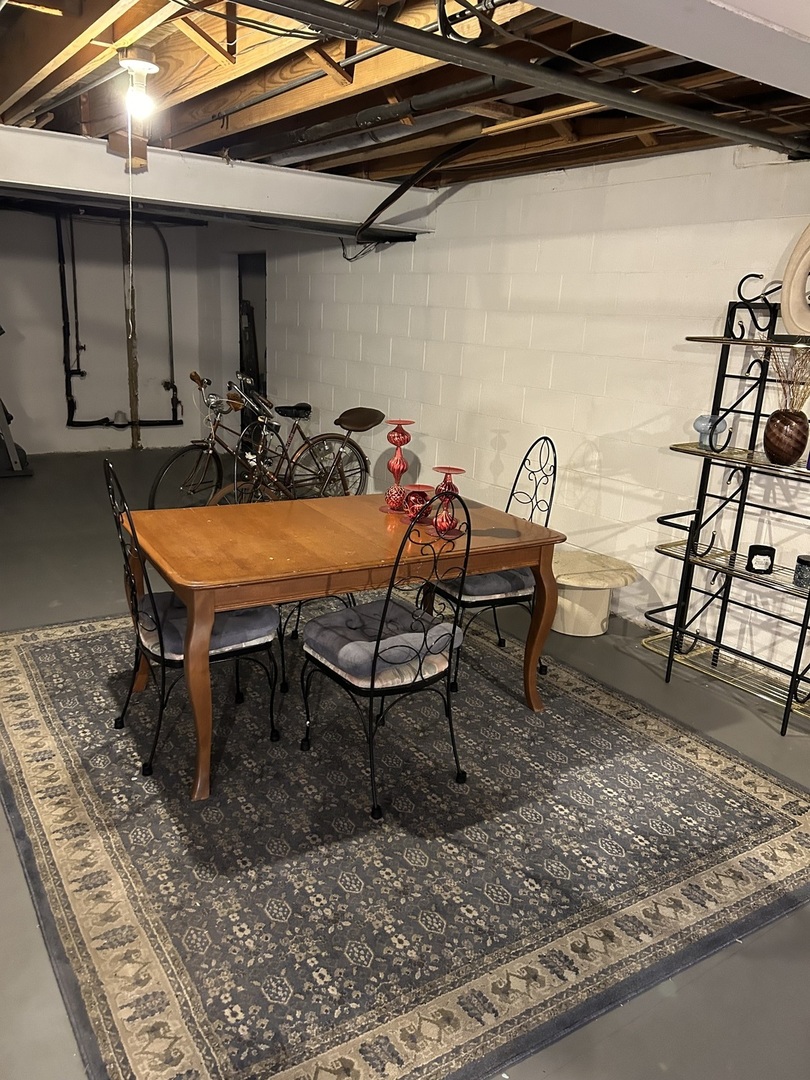 209 East Irving Park Road, Unit 1N Itasca, IL 60143 - Photo 28 of 30 a room with furniture and wooden floor