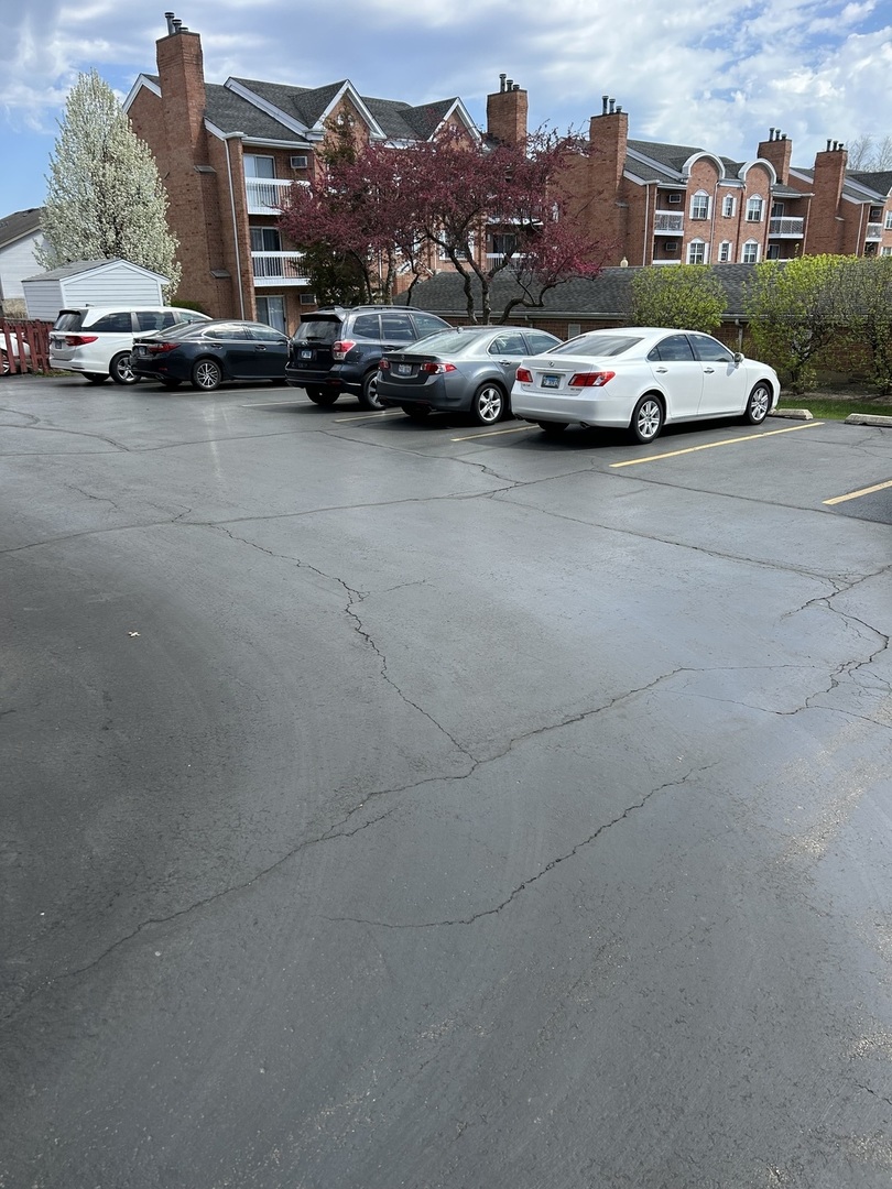 209 East Irving Park Road, Unit 1N Itasca, IL 60143 - Photo 3 of 30 a view of cars parked in a parking lot