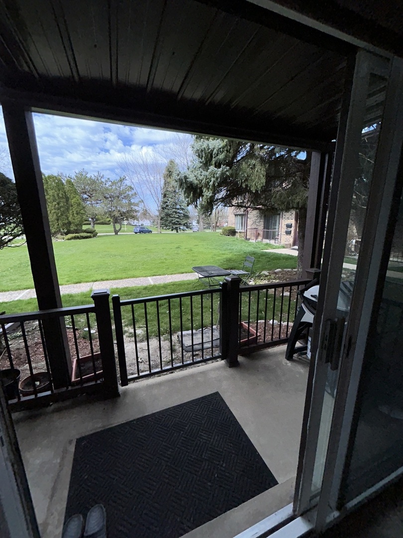 209 East Irving Park Road, Unit 1N Itasca, IL 60143 - Photo 7 of 30 a view of a porch with furniture and garden