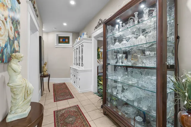 a kitchen with stainless steel appliances granite countertop a stove top oven a sink dishwasher a dining table and chairs with wooden floor