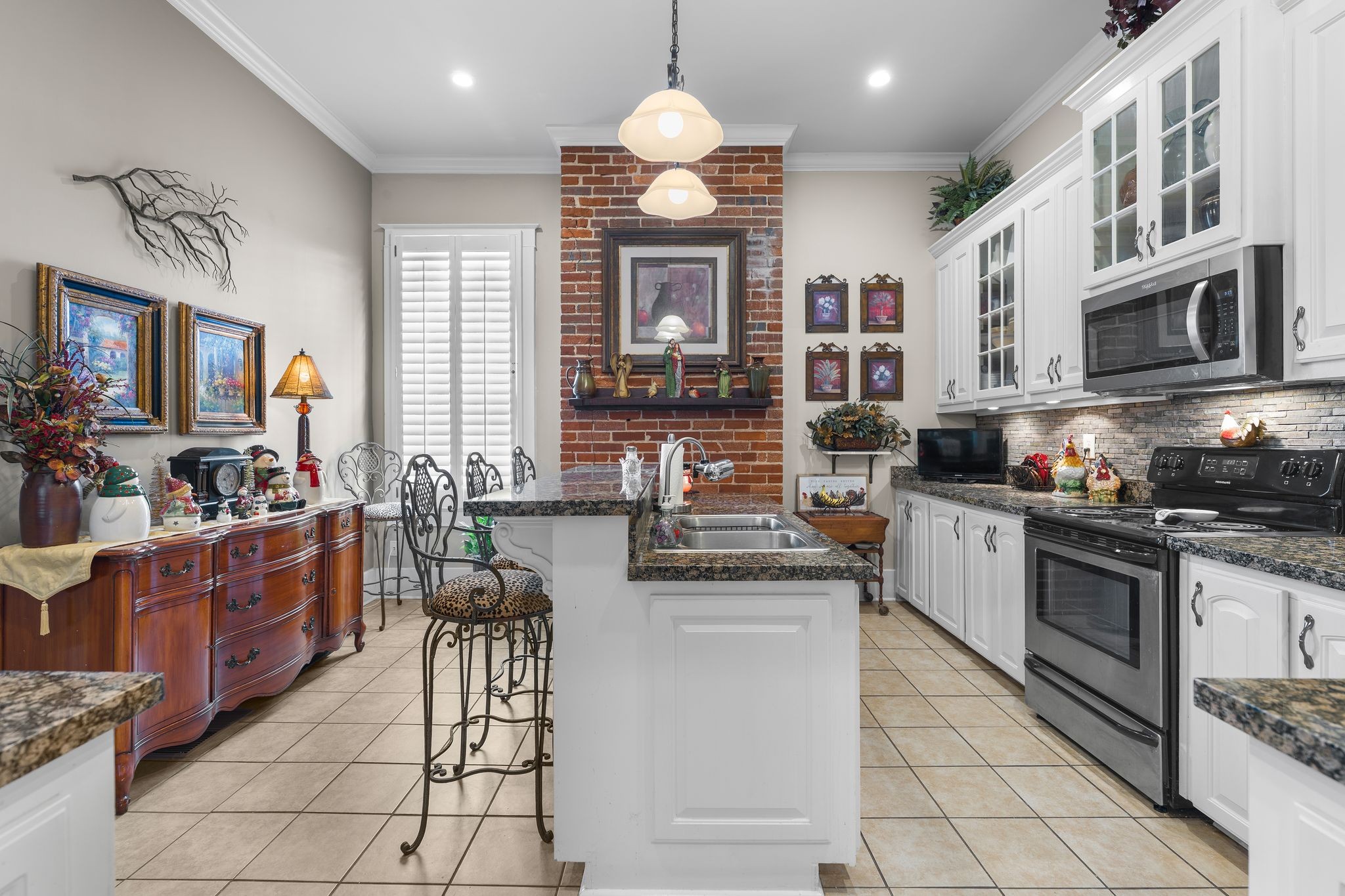 564 East Main Street Jackson, TN 38301 - Photo 18 of 54 a kitchen with stainless steel appliances granite countertop a stove top oven a sink dishwasher a dining table and chairs with wooden floor
