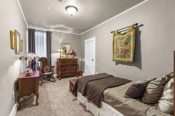 a bedroom with a bed and dresser