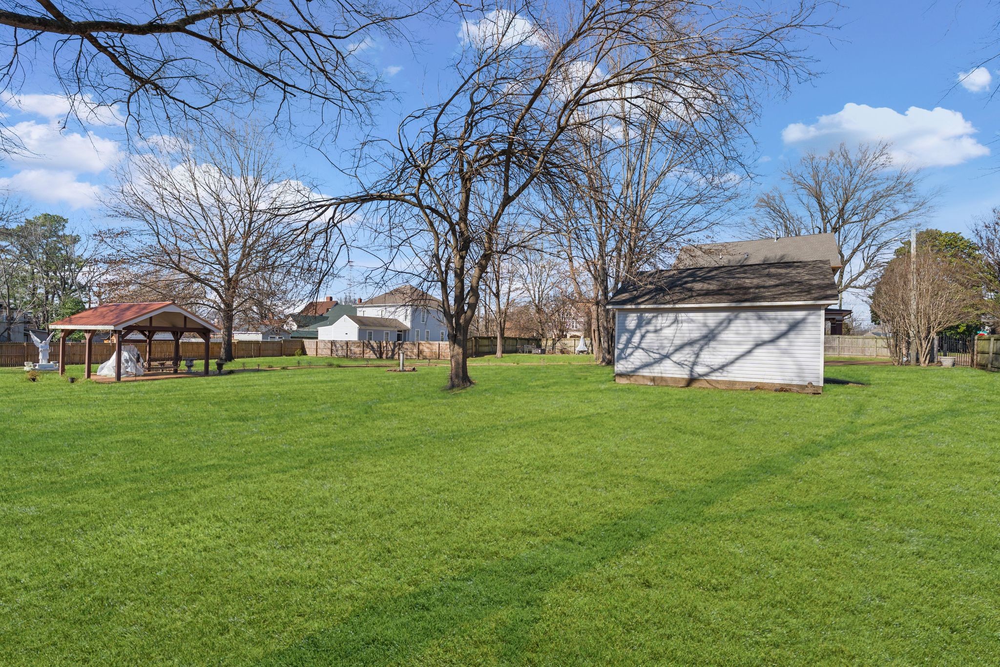 564 East Main Street Jackson, TN 38301 - Photo 49 of 54 a view of a white house with a big yard and large trees